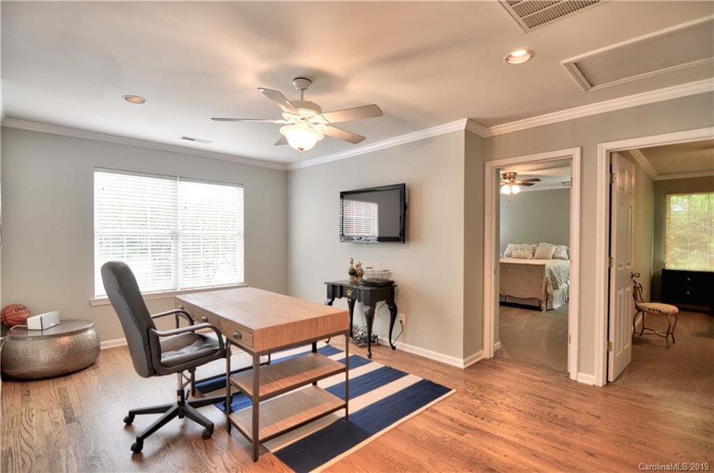 20210 Bascom Ridge Drive Cornelius, NC 28031 - Photo 18 of 35 a living room with furniture and a chandelier