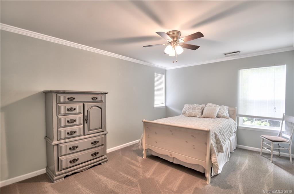 20210 Bascom Ridge Drive Cornelius, NC 28031 - Photo 21 of 35 a bedroom with a bed and a window