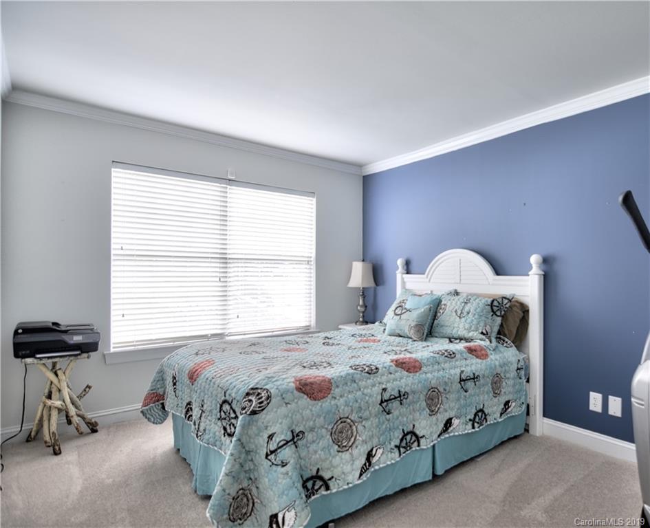 20210 Bascom Ridge Drive Cornelius, NC 28031 - Photo 22 of 35 a bedroom with a bed and a table in it