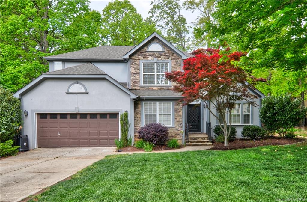 20210 Bascom Ridge Drive Cornelius, NC 28031 - Photo 4 of 35 a front view of a house with a garden and plants