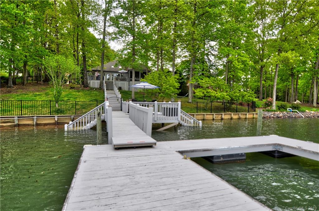 20210 Bascom Ridge Drive Cornelius, NC 28031 - Photo 33 of 35 a view of a lake with a deck