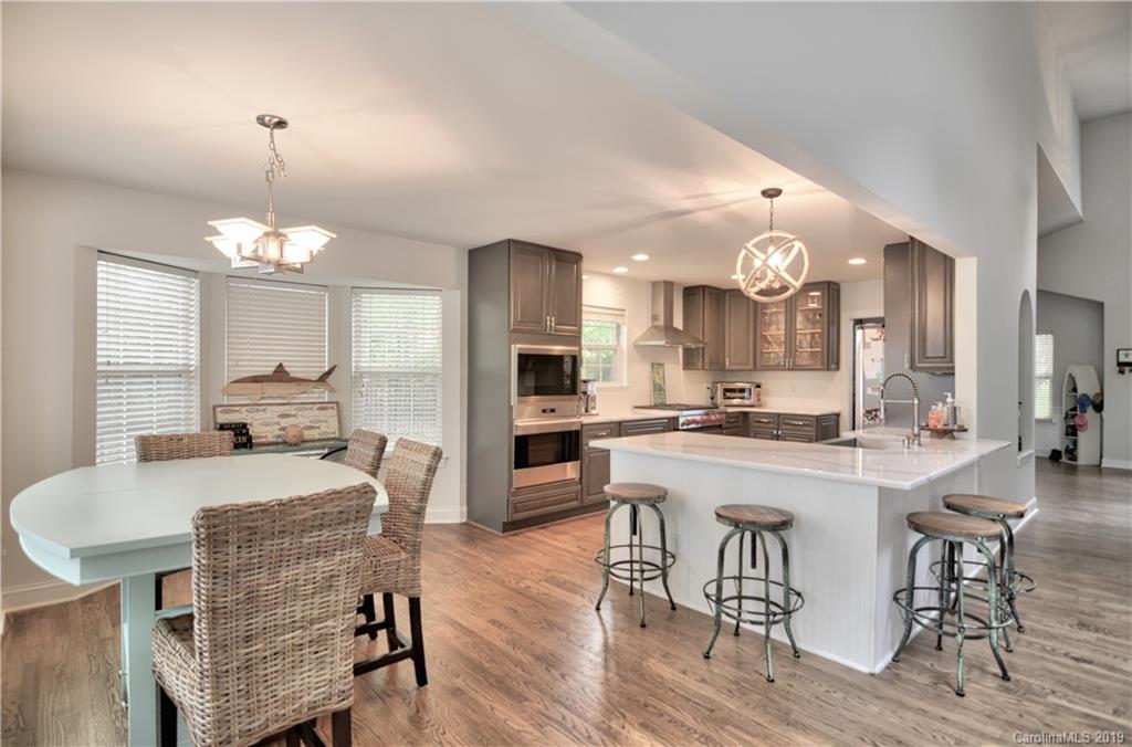 20210 Bascom Ridge Drive Cornelius, NC 28031 - Photo 8 of 35 a large kitchen with a table and chairs