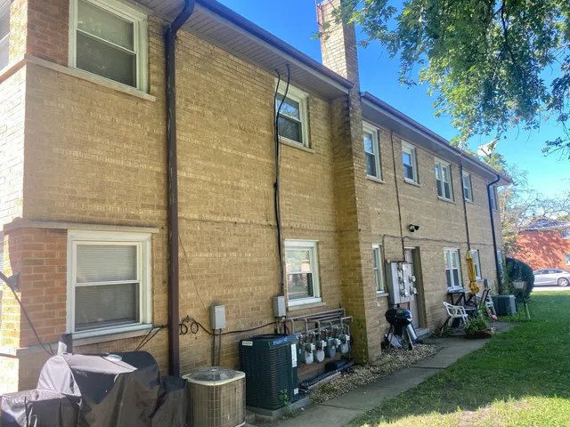 a front view of a house with outdoor seating