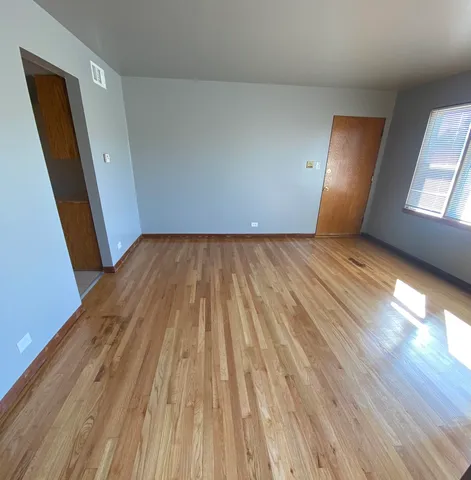 a view of an empty room and wooden floor