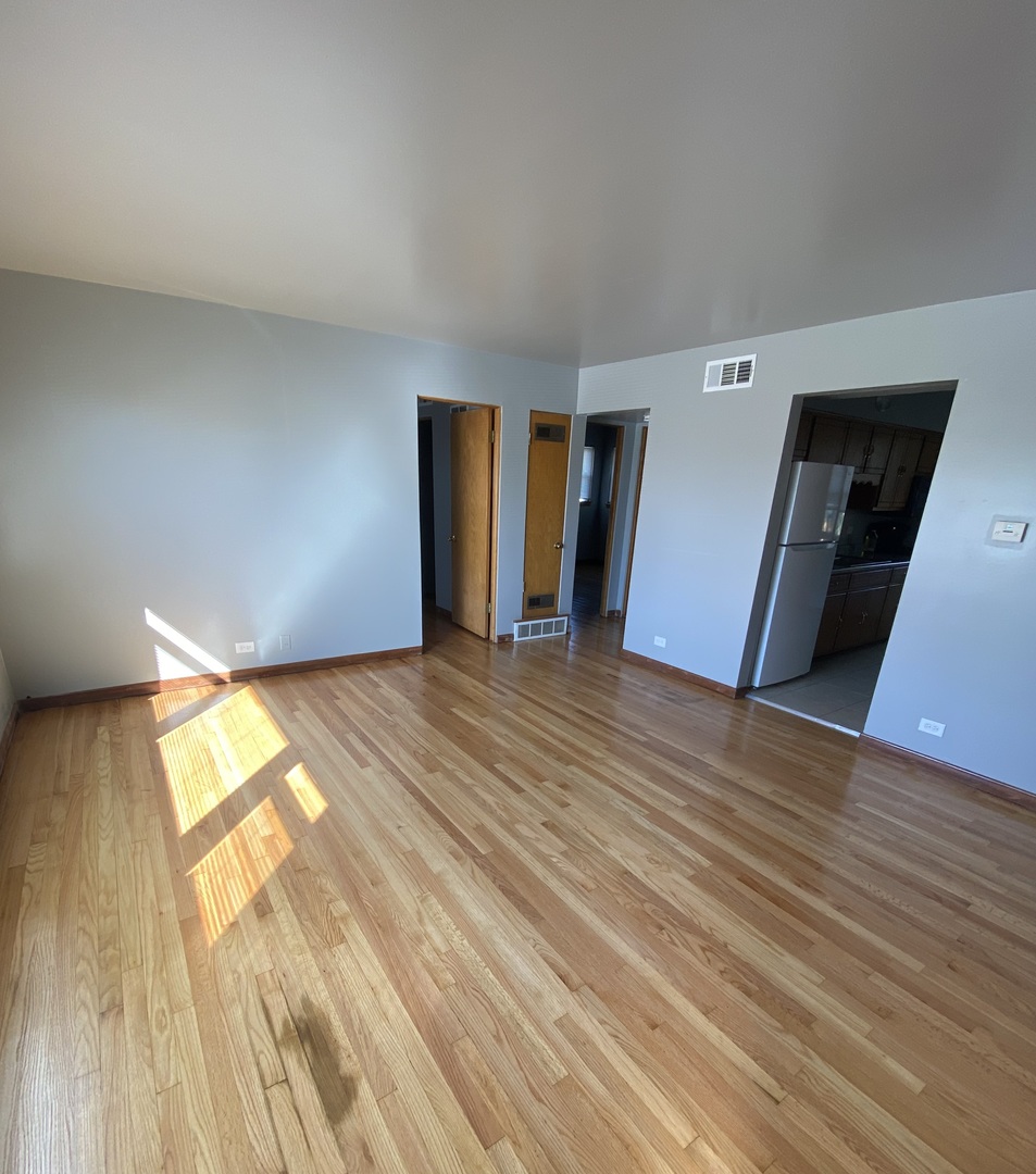 18231 Morgan Avenue, Unit 2N Homewood, IL 60430 - Photo 24 of 28 a view of empty room with wooden floor and fan