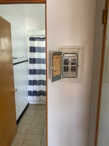 a view of a hallway with wooden shelves