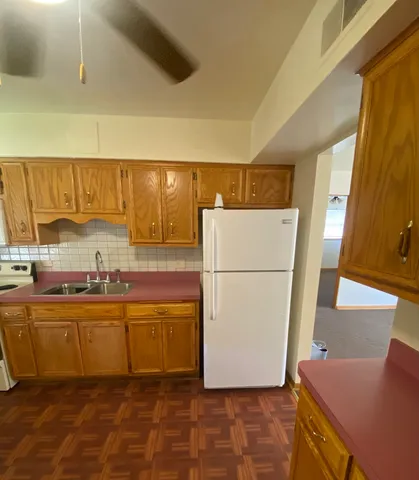 a kitchen with stainless steel appliances a refrigerator and a sink