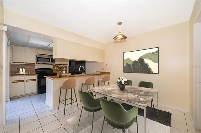 a kitchen with stainless steel appliances granite countertop a stove a sink a microwave and a refrigerator