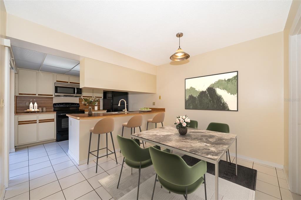 5258 Coral Court, Unit 605 Orlando, FL 32811 - Photo 12 of 41 a kitchen with stainless steel appliances granite countertop a stove a sink a microwave and a refrigerator