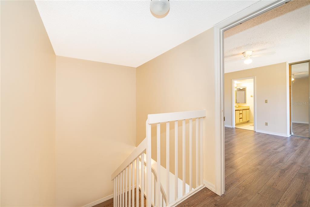 5258 Coral Court, Unit 605 Orlando, FL 32811 - Photo 19 of 41 a view of a hallway with wooden floor