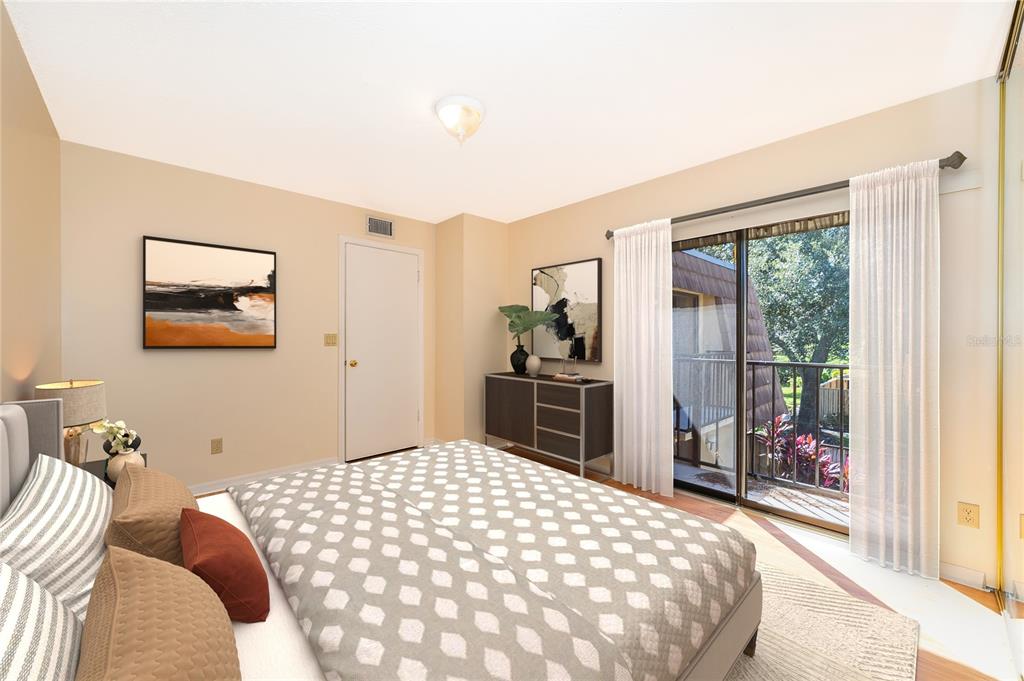 5258 Coral Court, Unit 605 Orlando, FL 32811 - Photo 20 of 41 a bedroom with a large bed and a chandelier