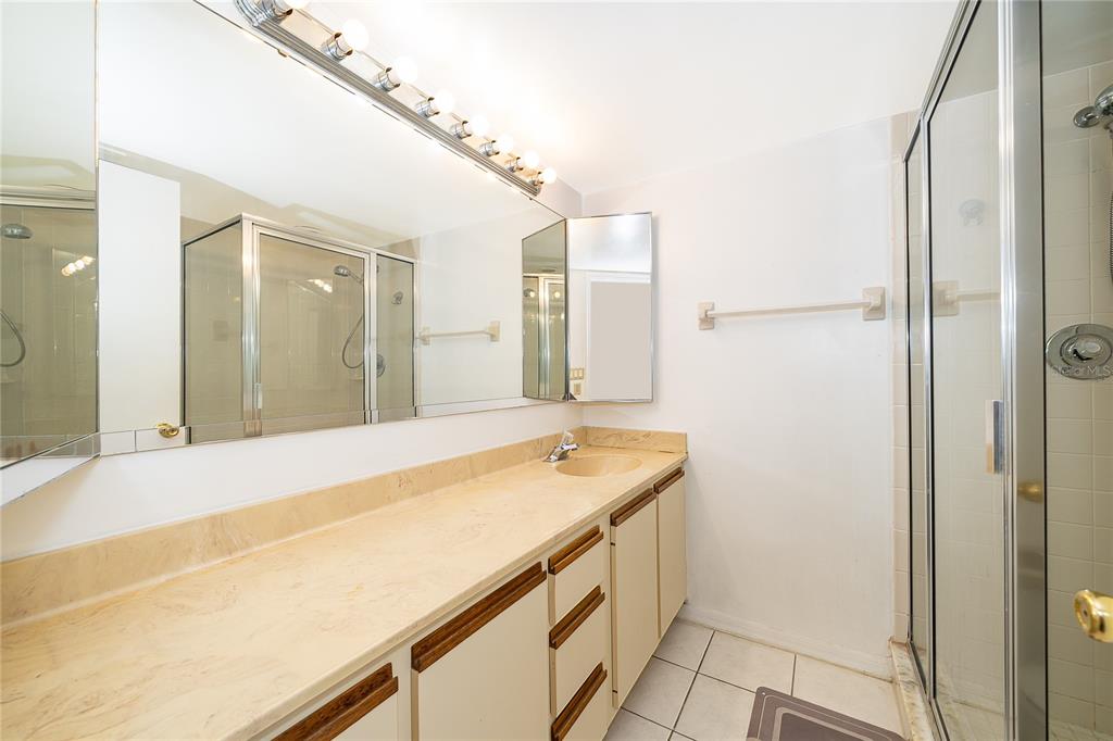 5258 Coral Court, Unit 605 Orlando, FL 32811 - Photo 24 of 41 a bathroom with a sink and a mirror