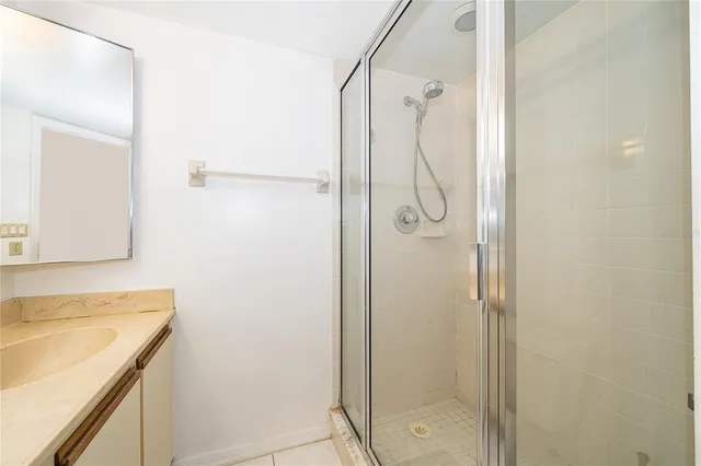 a bathroom with a granite countertop shower mirror and a sink