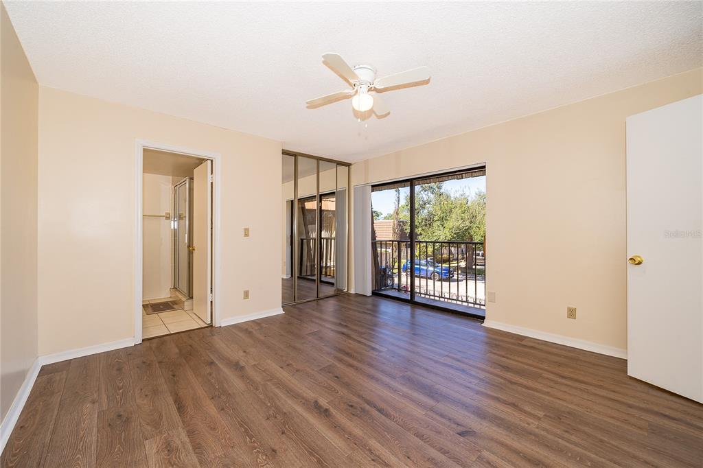 5258 Coral Court, Unit 605 Orlando, FL 32811 - Photo 27 of 41 a view of an empty room with wooden floor and a window