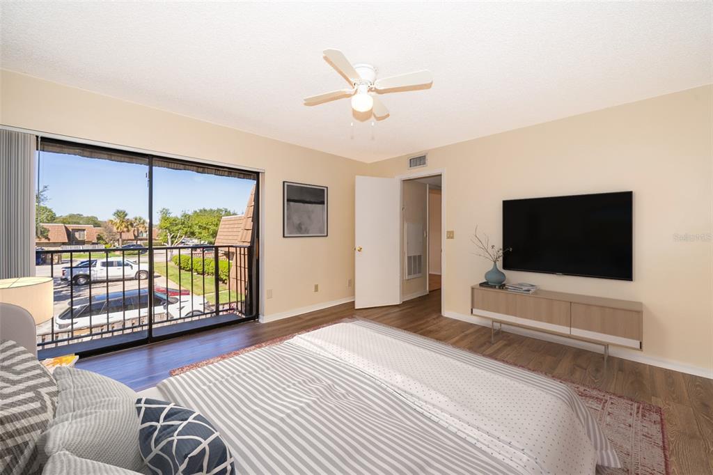 5258 Coral Court, Unit 605 Orlando, FL 32811 - Photo 28 of 41 a bedroom with a bed and glass window