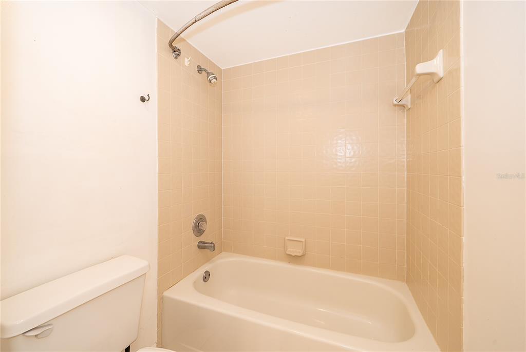 5258 Coral Court, Unit 605 Orlando, FL 32811 - Photo 30 of 41 a bathroom with a bathtub
