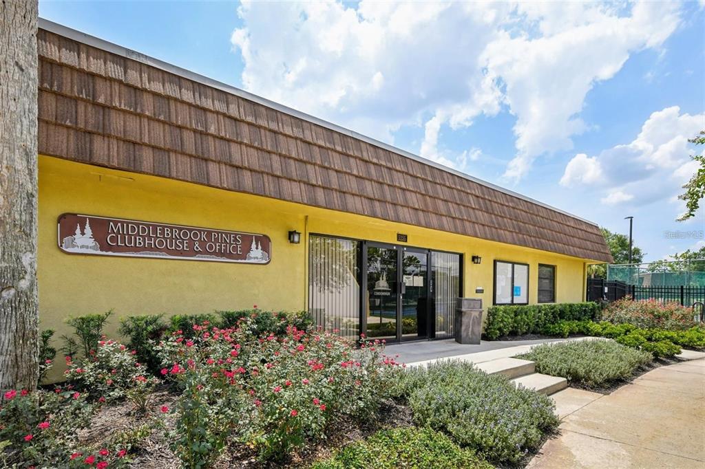 5258 Coral Court, Unit 605 Orlando, FL 32811 - Photo 40 of 41 a sign that is in front of flowers