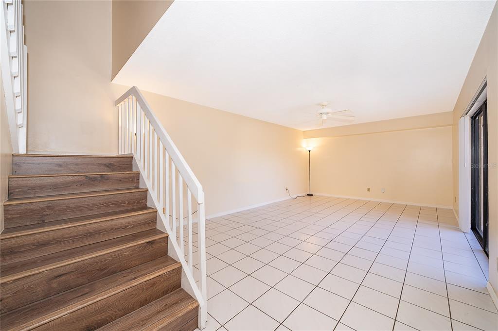 5258 Coral Court, Unit 605 Orlando, FL 32811 - Photo 5 of 41 a view of an empty room with stairs