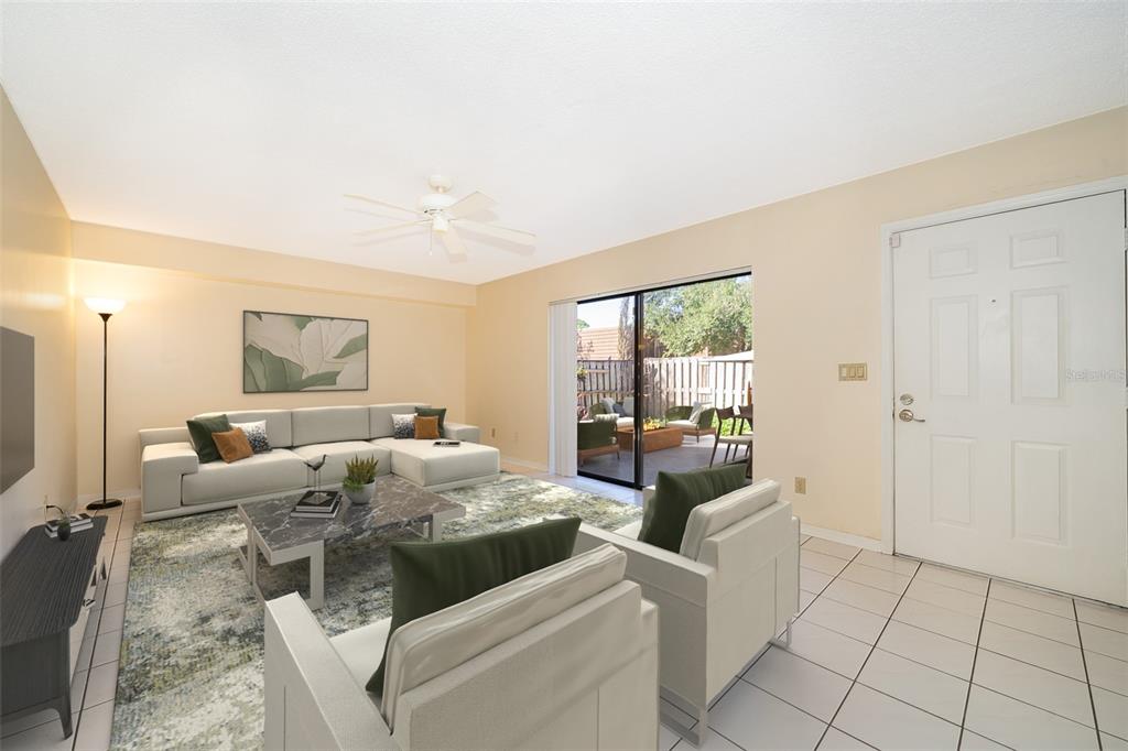 5258 Coral Court, Unit 605 Orlando, FL 32811 - Photo 6 of 41 a living room with furniture and a large window