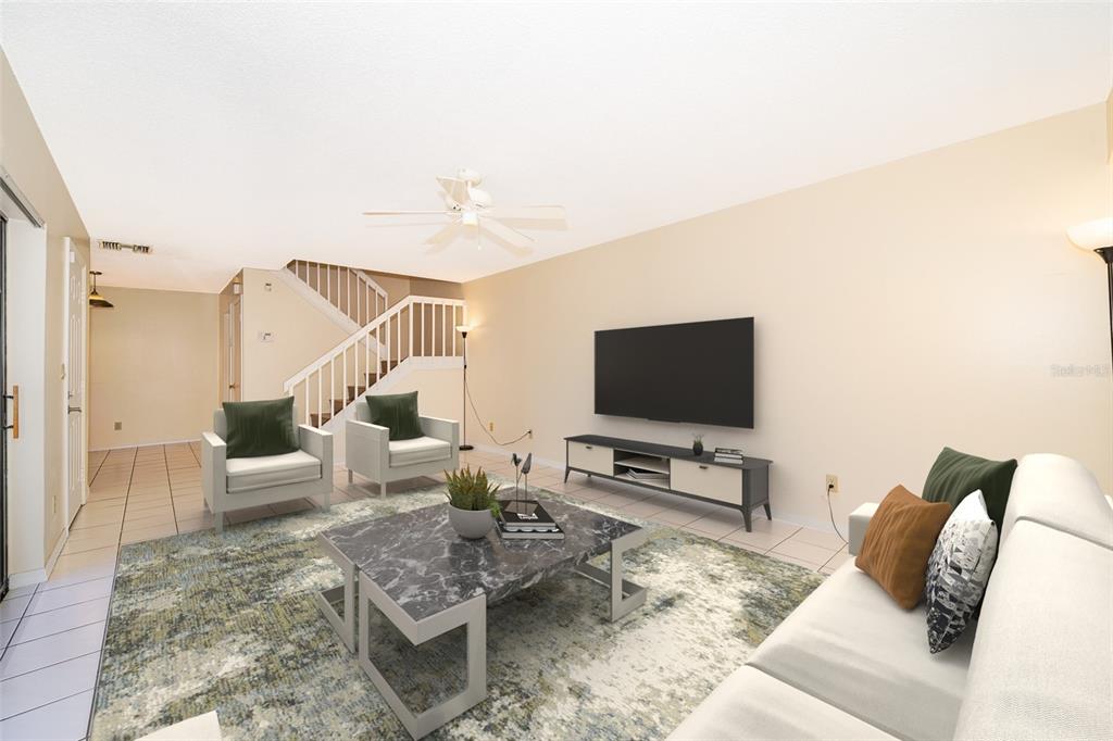 5258 Coral Court, Unit 605 Orlando, FL 32811 - Photo 8 of 41 a living room with furniture and a flat screen tv