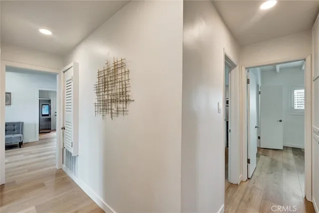 a view of a hallway with a livingroom and a bath tub
