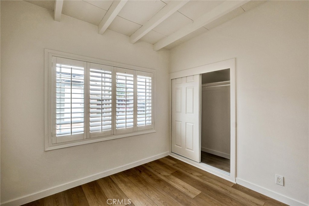 1401 West 165th Street Compton, CA 90220 - Photo 13 of 31 a view of an empty room with wooden floor and a window