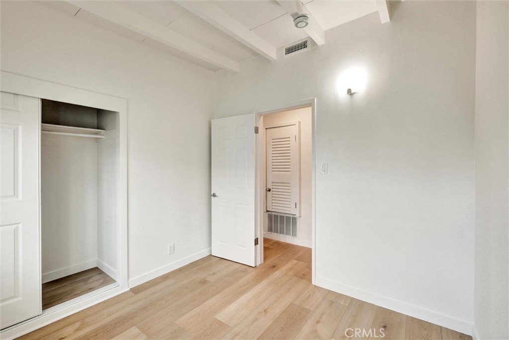 1401 West 165th Street Compton, CA 90220 - Photo 14 of 31 an empty room with wooden floor and windows