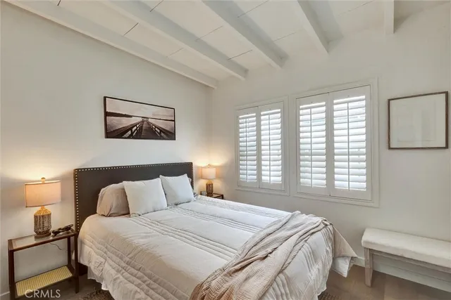 a bedroom with a bed and a painting on the wall