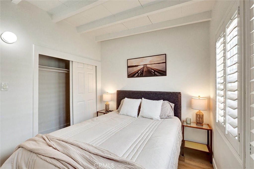 1401 West 165th Street Compton, CA 90220 - Photo 16 of 31 a bedroom with a bed and a painting on the wall