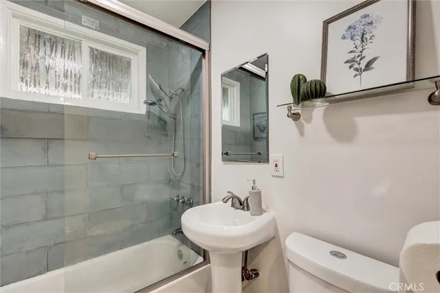 a bathroom with a sink mirror toilet and bathtub