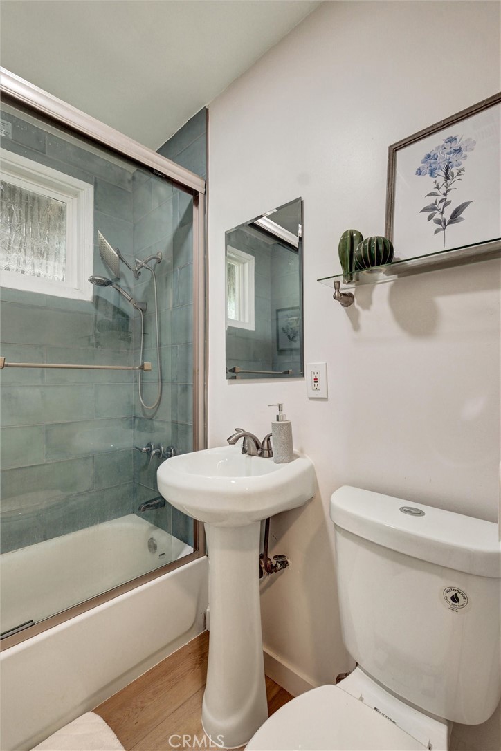 1401 West 165th Street Compton, CA 90220 - Photo 18 of 31 a bathroom with a sink mirror toilet and bathtub