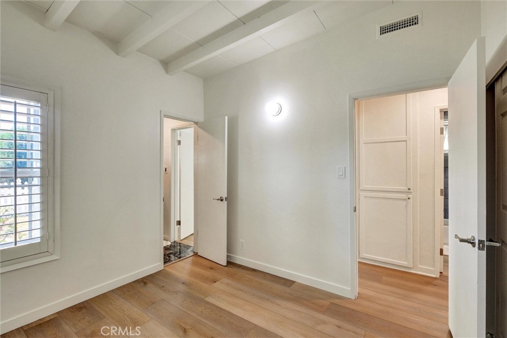 1401 West 165th Street Compton, CA 90220 - Photo 20 of 31 an empty room with wooden floor and windows
