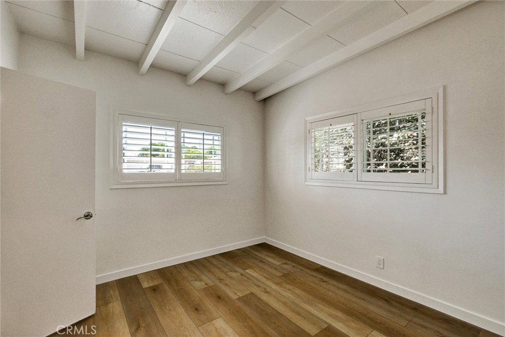 1401 West 165th Street Compton, CA 90220 - Photo 21 of 31 a view of an empty room with wooden floor and a window
