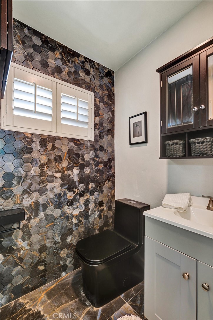 1401 West 165th Street Compton, CA 90220 - Photo 23 of 31 a bathroom with a sink a toilet and a window
