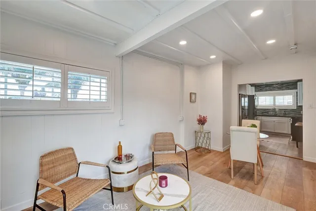 a dining room with furniture a window and wooden floor