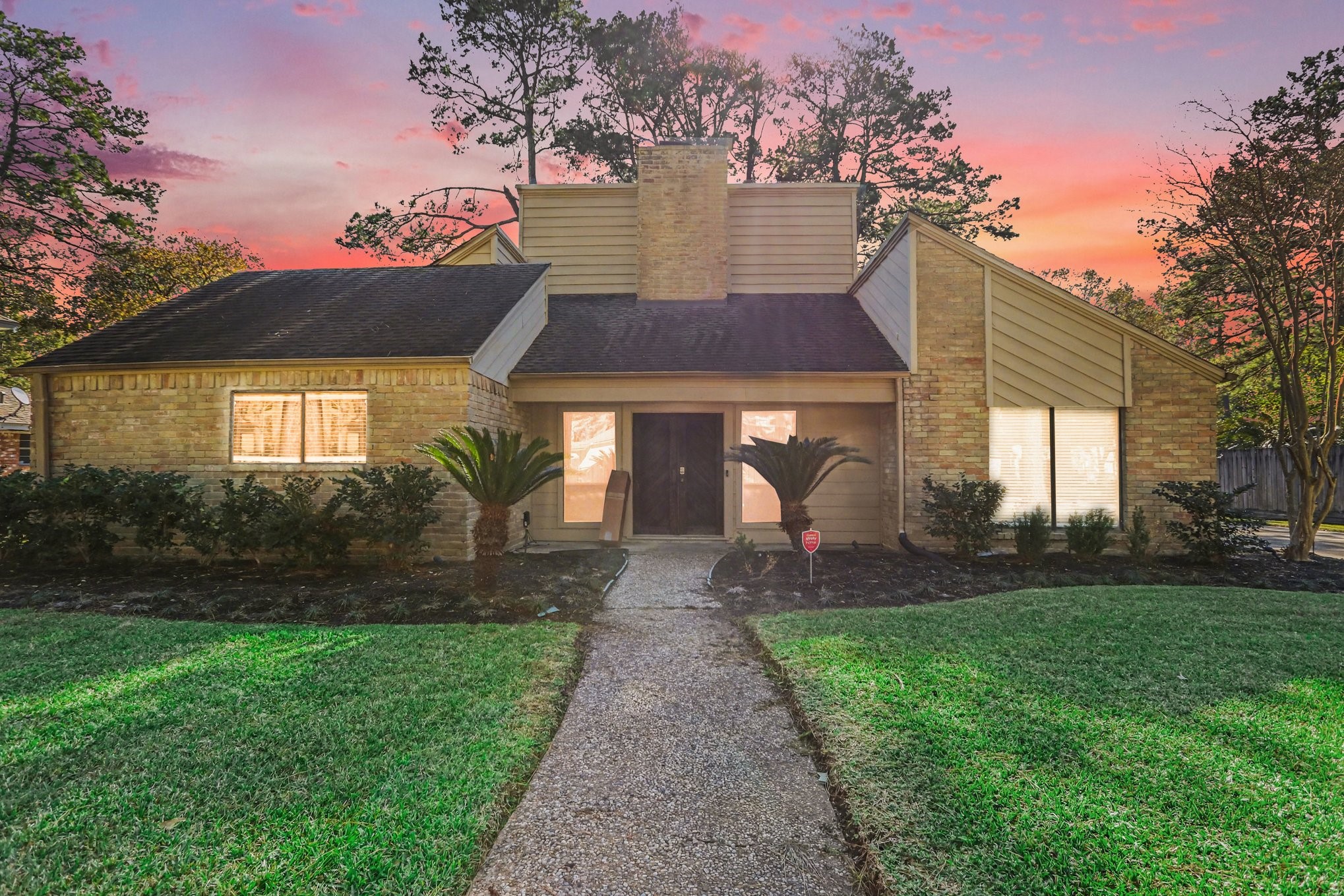 a front view of a house with garden