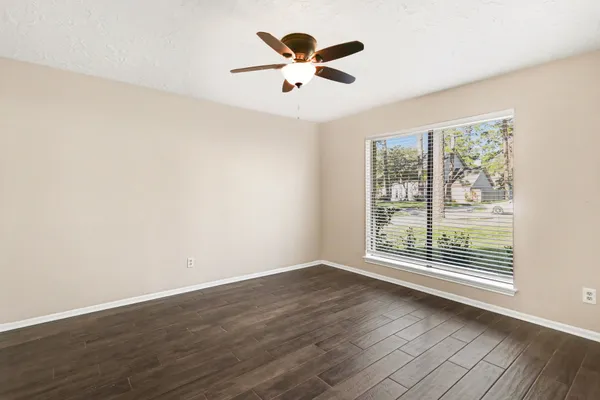 wooden floor in an empty room with a window