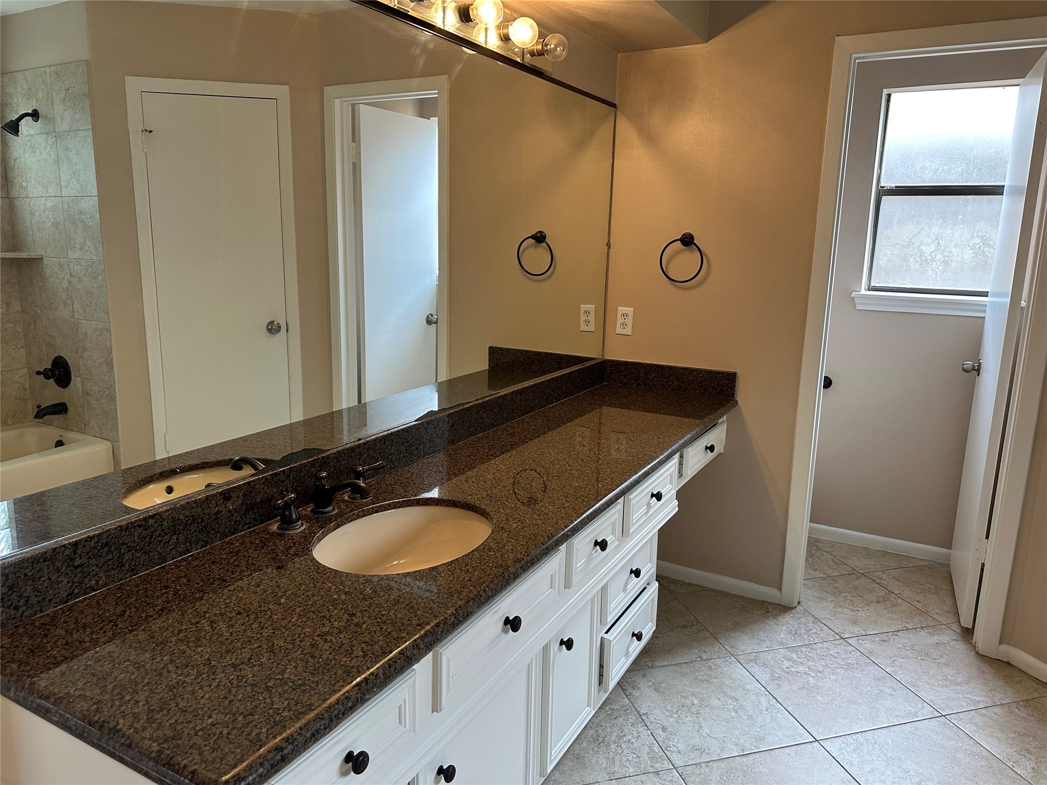 17406 Spicewood Springs Lane Spring, TX 77379 - Photo 20 of 50 a bathroom with a granite countertop sink and a mirror