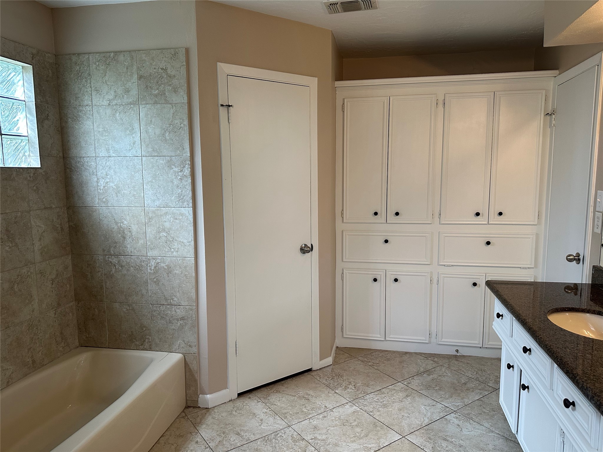 17406 Spicewood Springs Lane Spring, TX 77379 - Photo 21 of 50 a spacious bathroom with a granite countertop tub sink and mirror