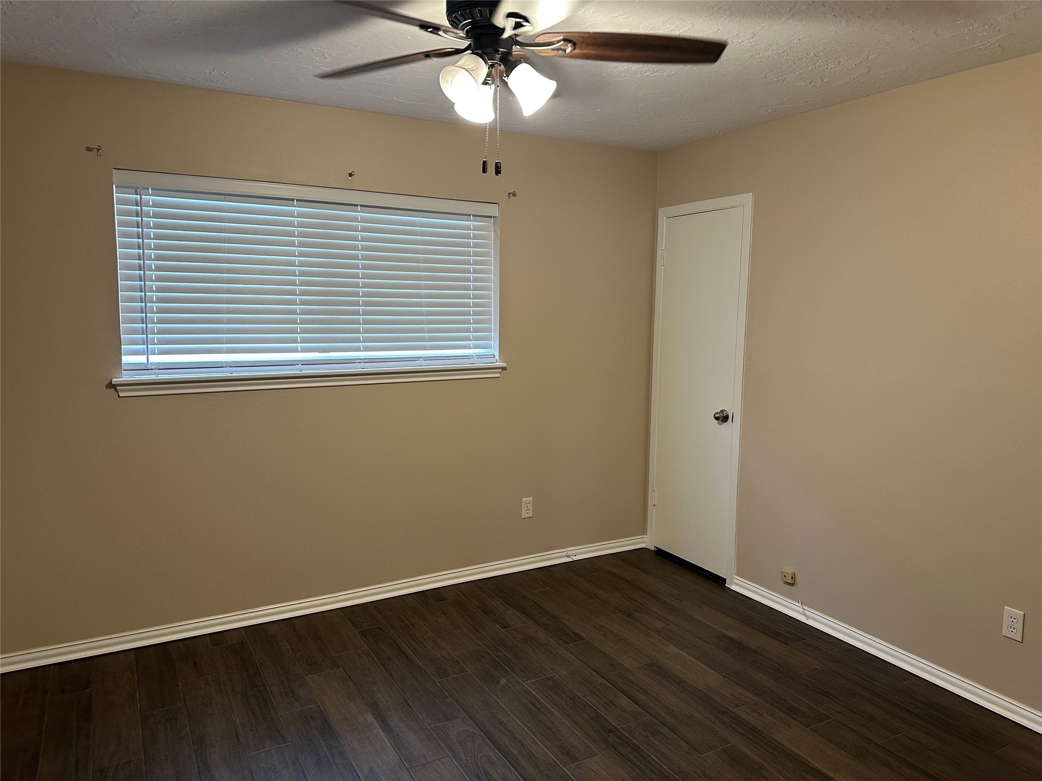 17406 Spicewood Springs Lane Spring, TX 77379 - Photo 26 of 50 a view of an empty room with wooden floor and a window