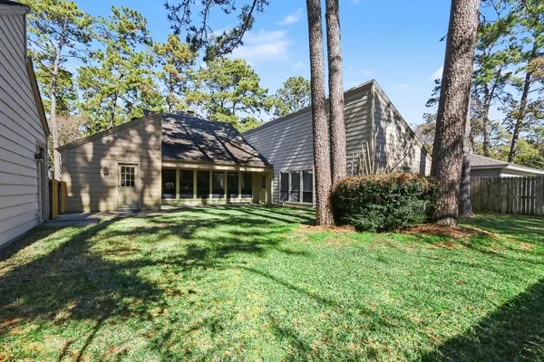 a view of an house with backyard space and garden
