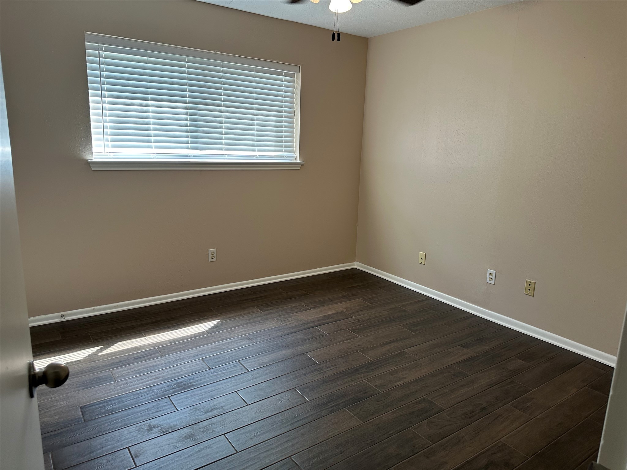 17406 Spicewood Springs Lane Spring, TX 77379 - Photo 31 of 50 an empty room with wooden floor and windows