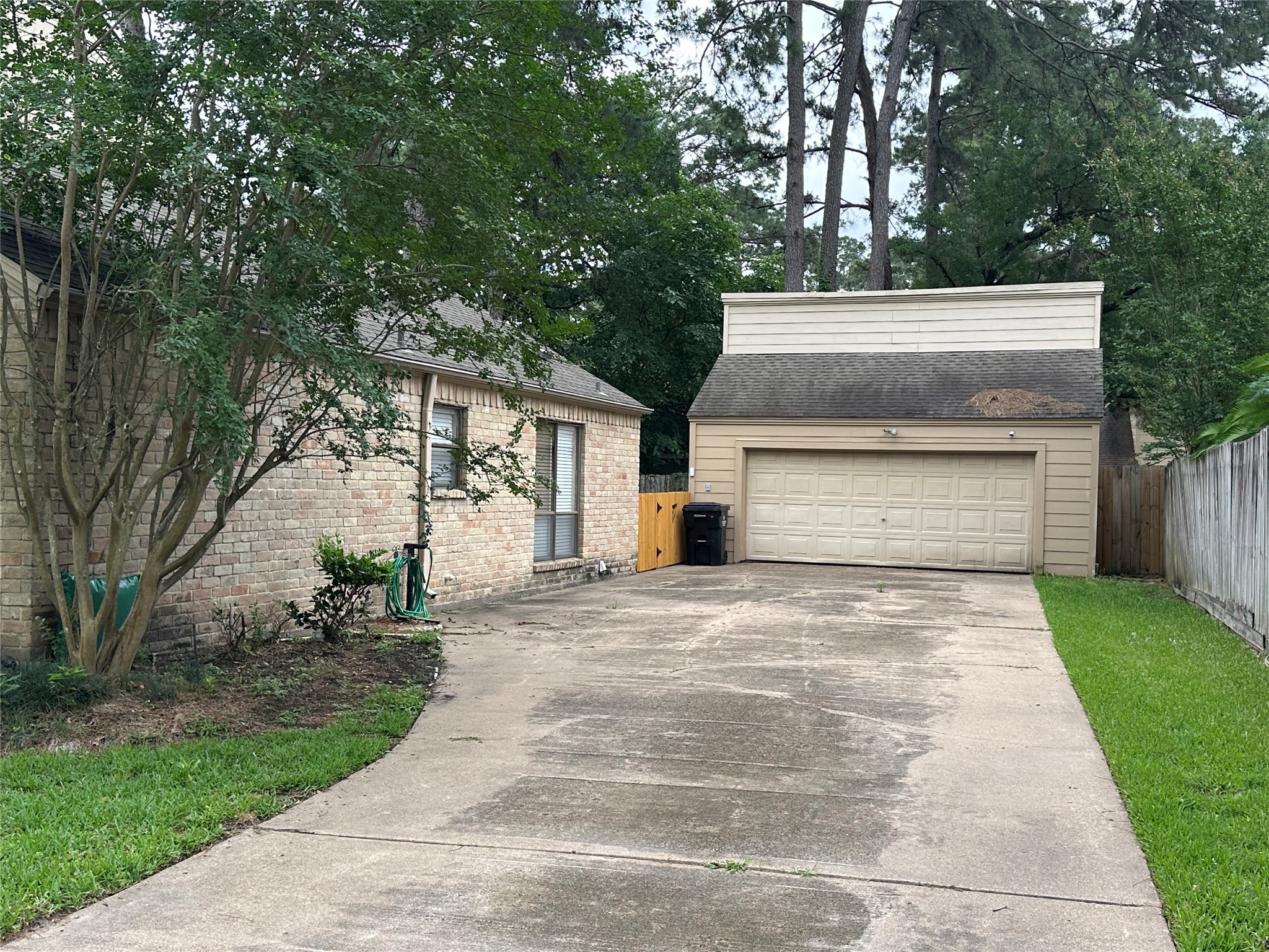 17406 Spicewood Springs Lane Spring, TX 77379 - Photo 32 of 50 a view of white house with a yard plants and large tree