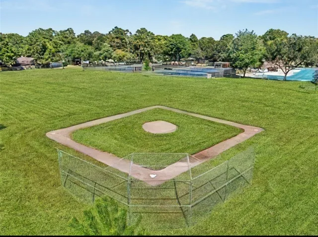 a view of a park with iron fence
