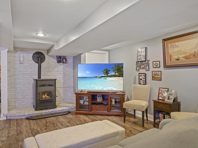 9 Middlefield Place Acushnet, MA 02743 - Photo 14 of 14 a living room with furniture a flat screen tv and a fireplace