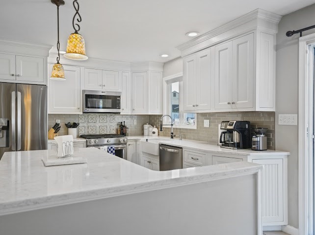 9 Middlefield Place Acushnet, MA 02743 - Photo 7 of 14 a kitchen with stainless steel appliances granite countertop a sink a stove a refrigerator cabinets and a window