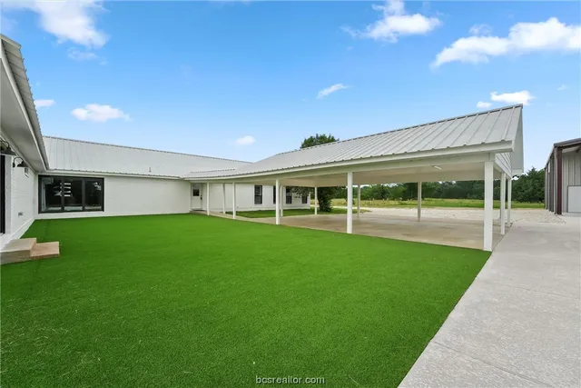 a view of house with a backyard