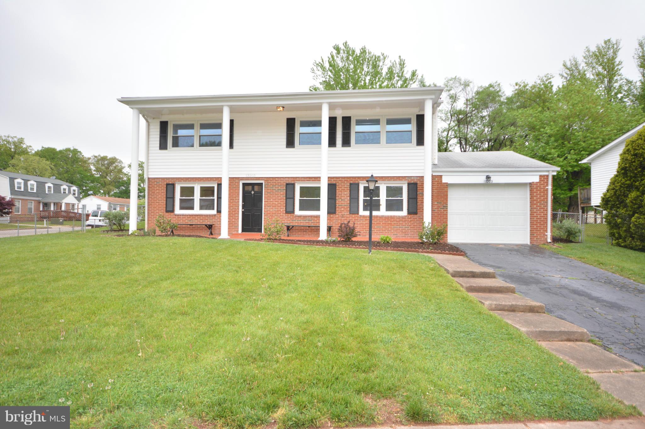 13203 Delaney Road Woodbridge, VA 22193 - Photo 2 of 30 a front view of a house with a yard and trees