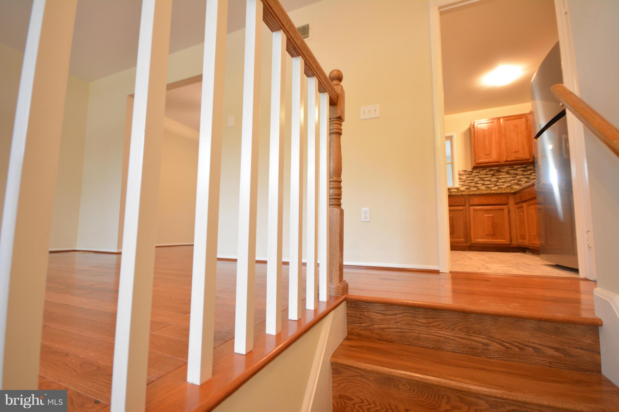 13203 Delaney Road Woodbridge, VA 22193 - Photo 13 of 30 a view of a hallway with wooden floor and a sink