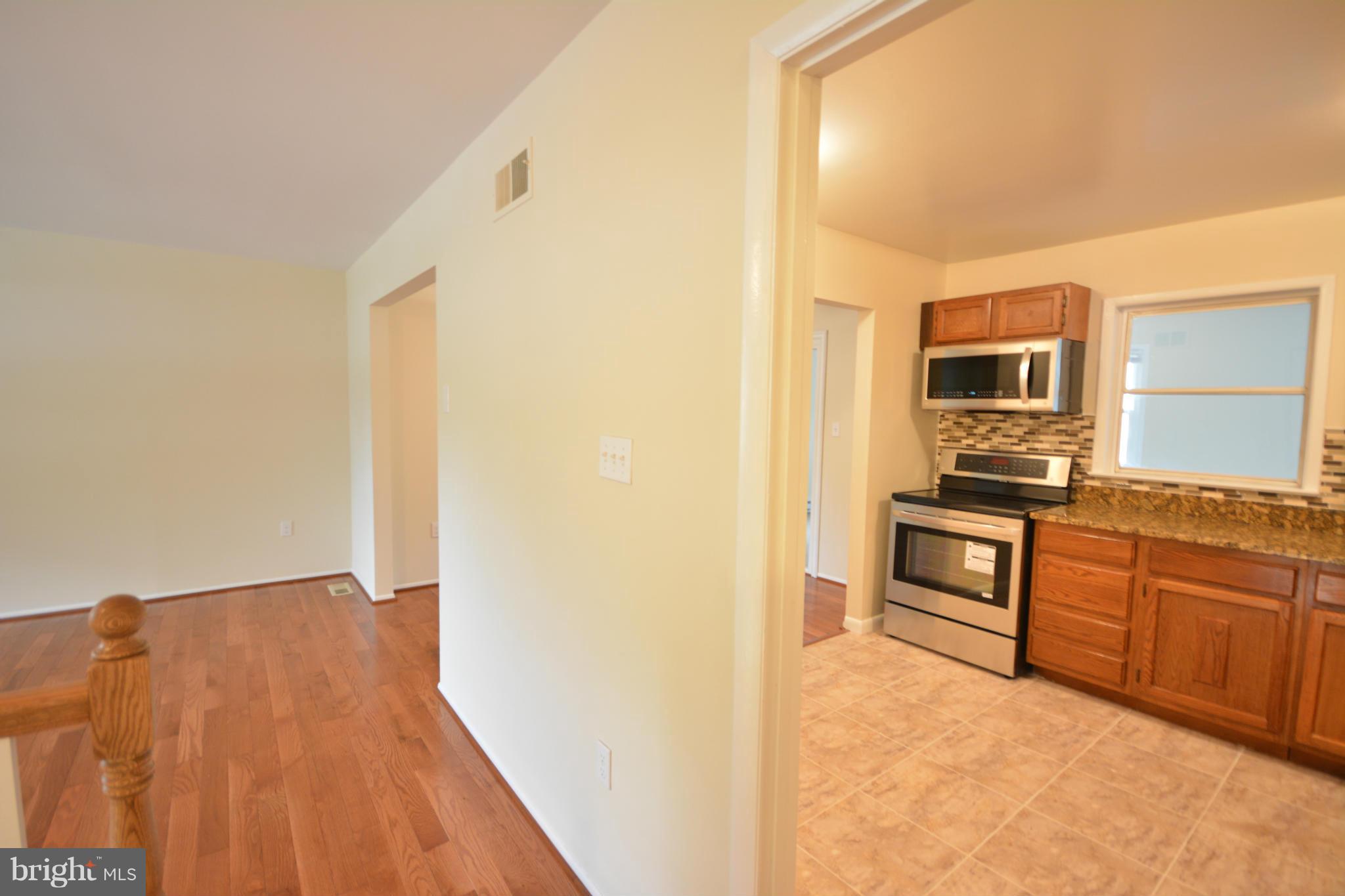 13203 Delaney Road Woodbridge, VA 22193 - Photo 15 of 30 a view of kitchen with microwave and stove